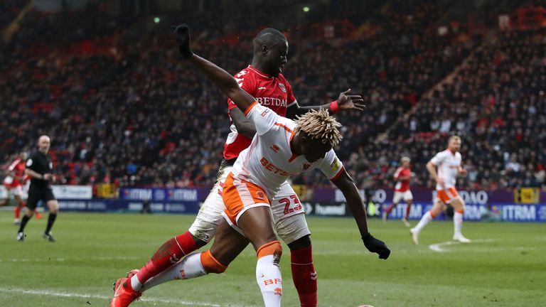 Blackpool's Armand Gnanduillet is challenged by Charlton's Naby Sarr during the Sky Bet League One clash