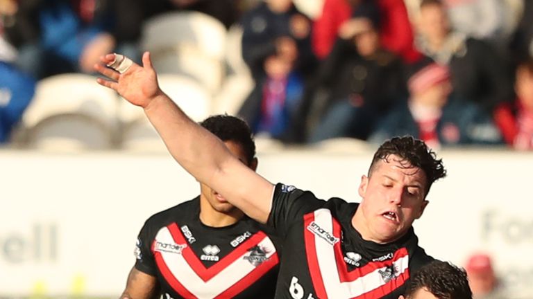 Craig Hall of Hull KR offloads the ball before he is brought down