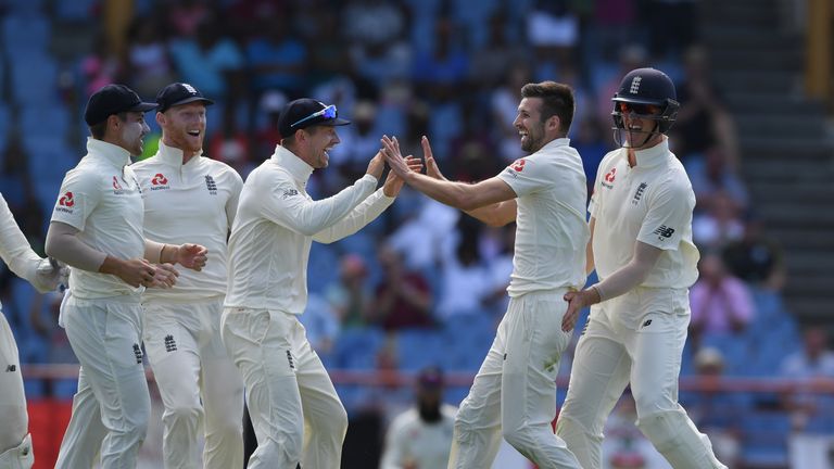 Mark Wood celebrates a wicket with team-mate Jos Buttler