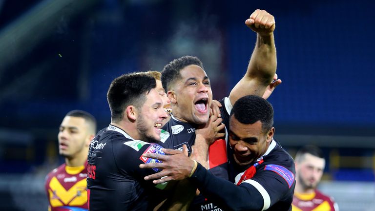 Salford Red Devils's Derrell Olpherts celebrates with team mates after scoring