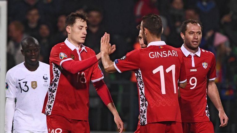 Vladimir Ambros is congratulated by team-mates after scoring his consolation