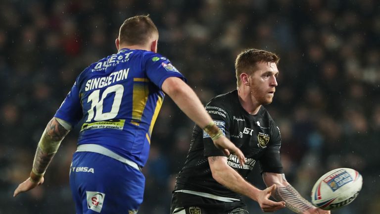 Marc Sneyd passes the ball as Brad Singleton of Leeds Rhinos approaches