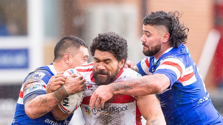 Hull KR's Mose Masoe is tackled by Wakefield's Tinirau Arona & David Fifita