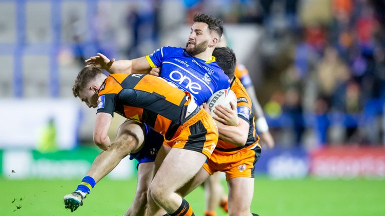 Toby King is tackled by Castleford's Jake Trueman and Matt Cook