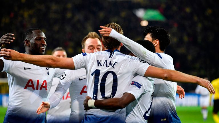 Kane is mobbed by team-mates after making it 1-0