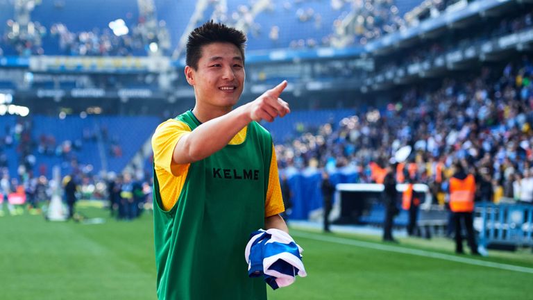 Wu points to a fan before giving them his shirt