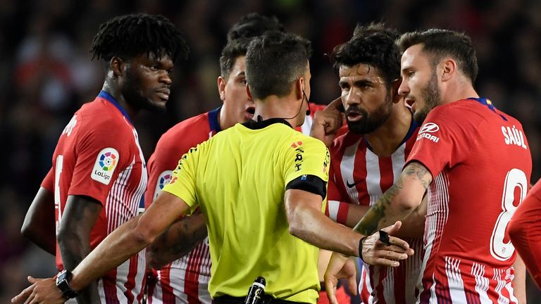 Diego Costa talks with referee Gil Manzano prior to receiving a red card against Barcelona