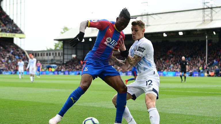 Crystal Palace's Aaron Wan-Bissaka shields the ball from Lucas Digne of Everton