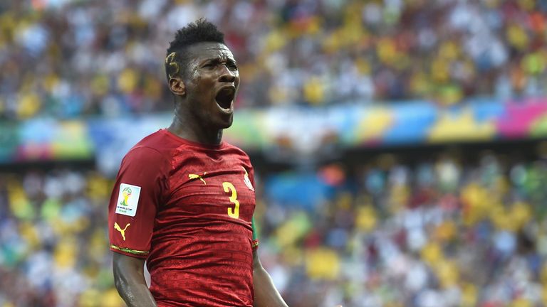Asamoah Gyan celebrating scoring at the 2014 World Cup.