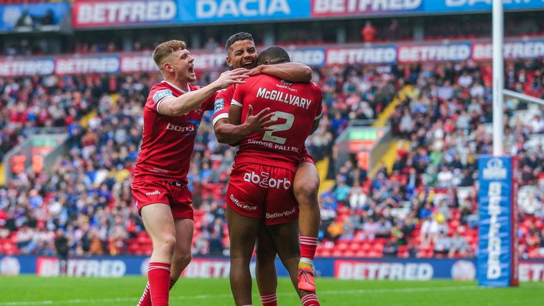 Jermaine McGillvary celebrates his first try with his Huddersfield team-mates