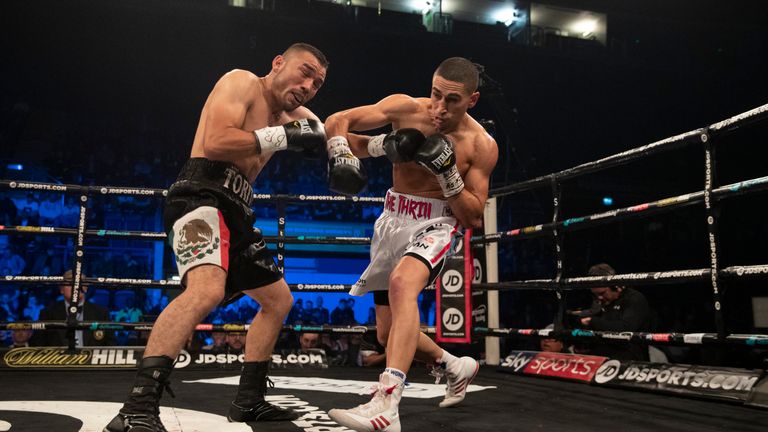 Gill catches Tinoco with a right hook during their featherweight showdown