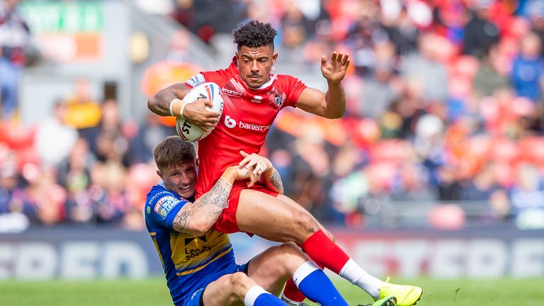 Broncos winger Kieran Dixon is tackled by Ash Handley