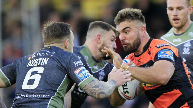 Mike McMeeken tackled by Warrington's Daryl Clark and Blake Austin