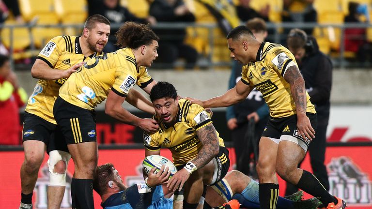 Ben Lam celebrates a try for the Hurricanes with his team-mates