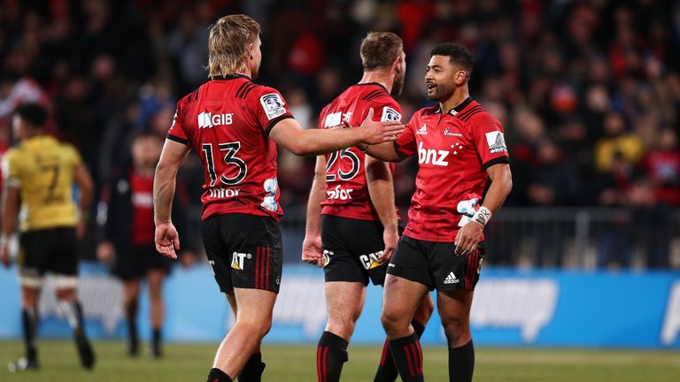 Richie Mo&#8217;unga and Jack Goodhue celebrate the Crusaders' win over the Hurricanes