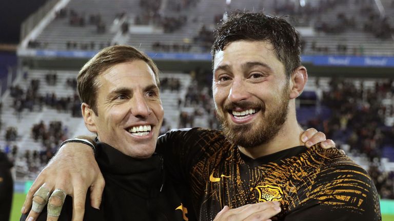 Jaguares head coach Gonzalo Quesada and number eight Javier Ortega Desio celebrate after defeating the Brumbies