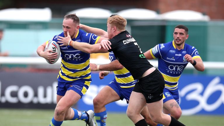 Warrington's Ben Currie fends off James Cunningham 