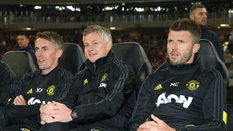 Solskjaer watches on from the sidelines with assistants Kieran McKenna and Michael Carrick