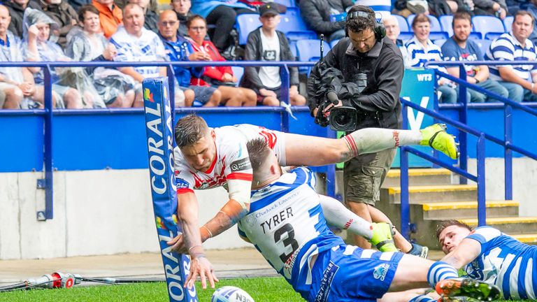 St Helens' Tommy Makinson is just pushed into touch by Stephen Tyrer