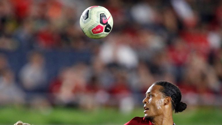 Liverpool defender Virgil van Dijk battles for the ball with Jacob Bruun Larsen