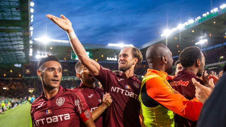 Cluj players celebrate in front of the away fans