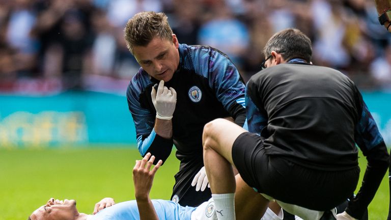 Sane receiving treatment after damaging his right knee