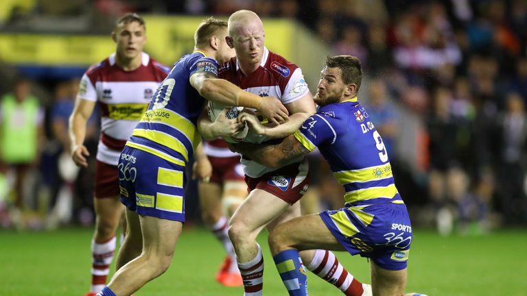 Wigan's Liam Farrell looks for a way through the Warrington defence