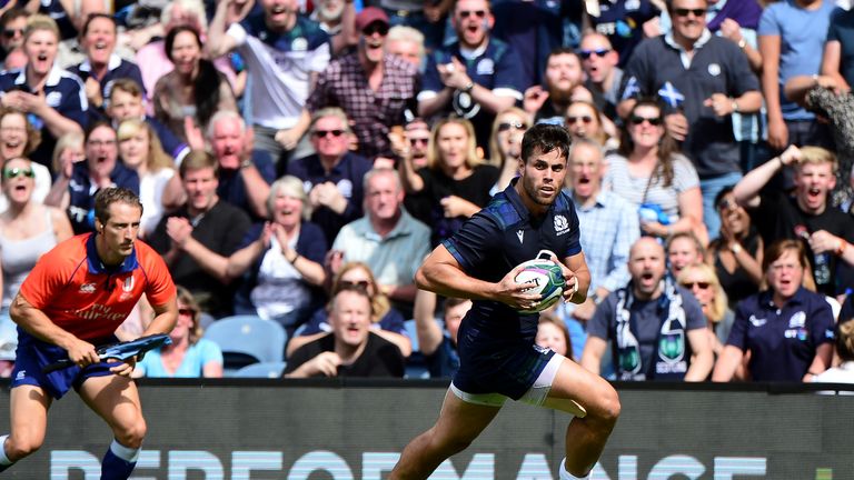 The crowd react as Sean Maitland receives the ball and charges for the try line