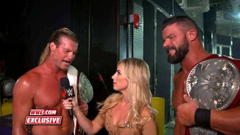Dolph Ziggler & Robert Roode celebrate their championship success over Seth Rollins and Braun Strowman