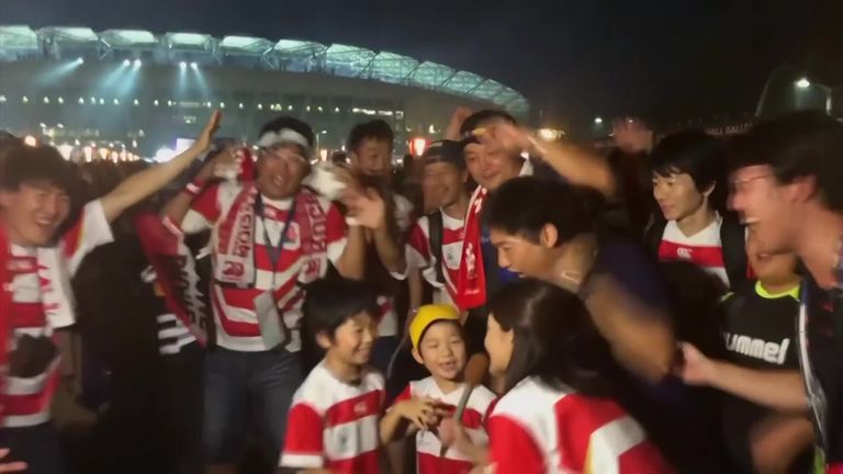 Japan supporters celebrate their country's historic victory over Ireland