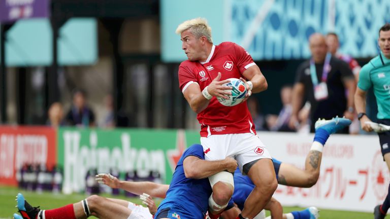 Canada's DTH Van Der Merwe looks to offload out of the tackle against Italy