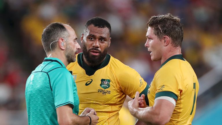 Michael Hooper (right) speaks to referee Romain Poite during Australia's loss to Wales