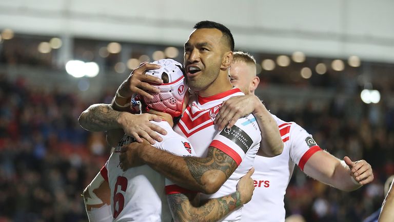 Theo Fages celebrates scoring St Helens' first try with Zeb Taia
