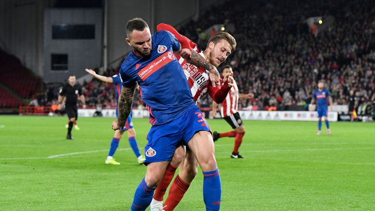 Joel Lynch of Sunderland battles for possession with Luke Freeman