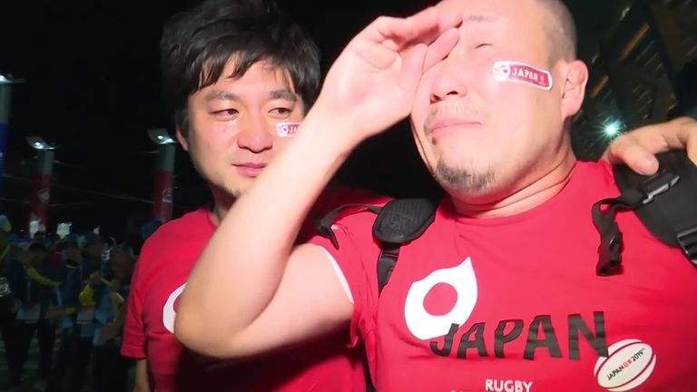 Japan fans celebrate their side's 28-21 win against Scotland that sealed them a first-ever spot in the Rugby World Cup quarter-finals.