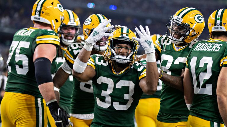 Aaron Jones celebrates his fourth touchdown in Green Bay's road win over Dallas