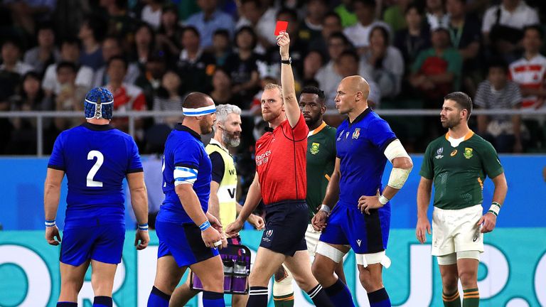 Referee Wayne Barnes gives a red card to Italy loosehead Andrea Lovotti (left) 