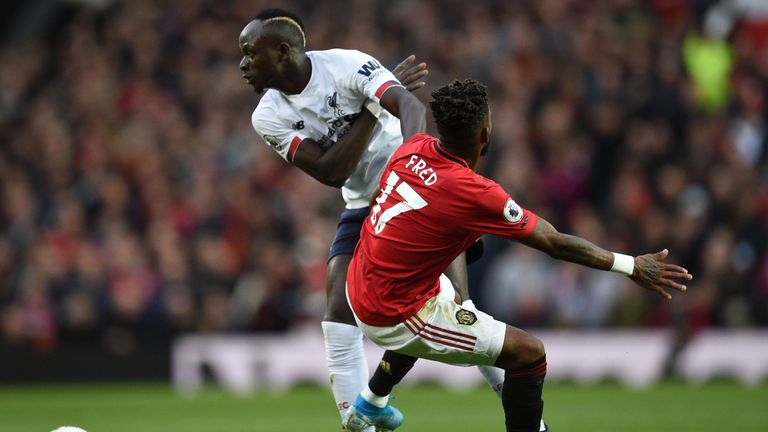 Fred and Sadio Mane compete for the ball