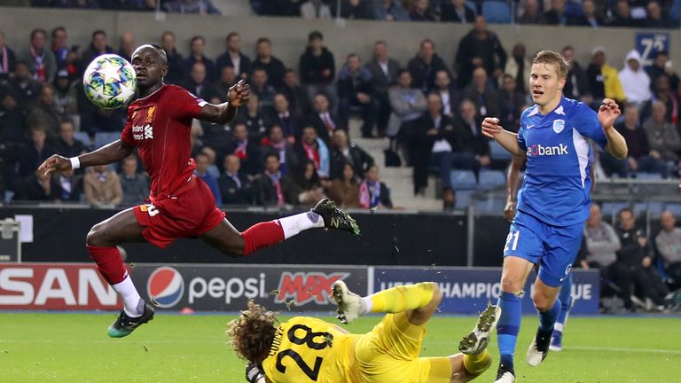 Sadio Mane lifts over goalkeeper Gaetan Coucke for Liverpool's third