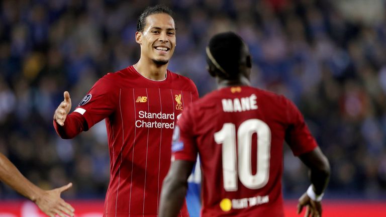 Sadio Mane celebrates with Virgil van Dijk after scoring against Genk in the Champions League