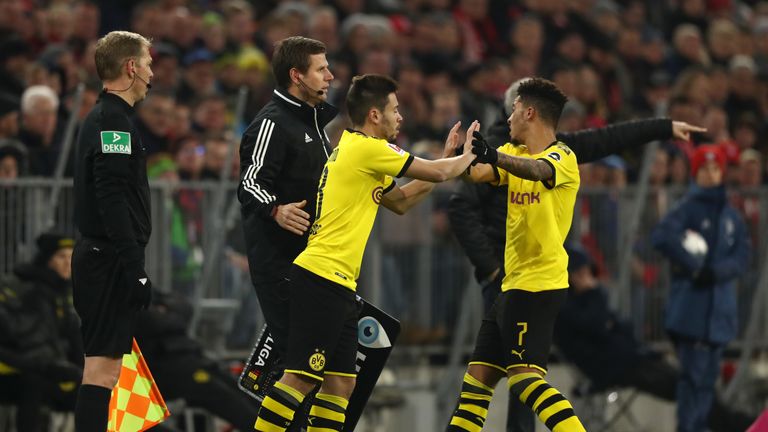 Sancho (r) is replaced by Raphael Guerreiro against Bayern Munich in the Allianz Arena