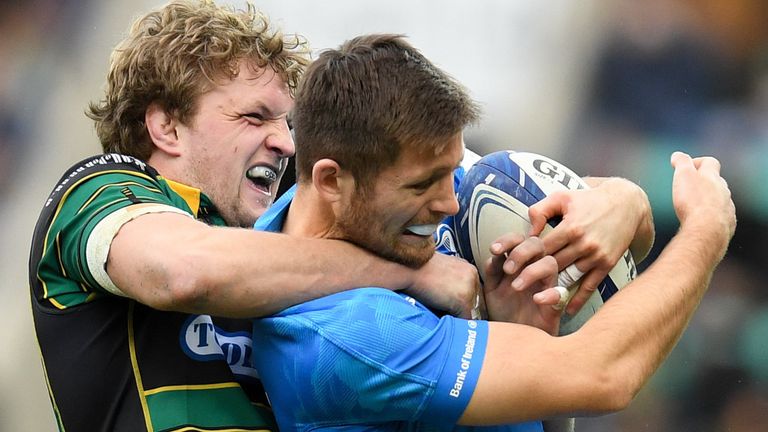 Ross Byrne is tackled by Northampton flanker Jamie Gibson