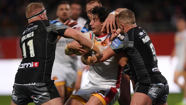 Catalans' Benjamin Garcia is wrapped up by Castleford defenders Oliver Holmes and Paul McShane