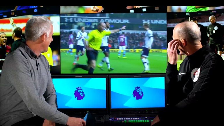 Mike Dean wheels away in celebration after Moussa Dembele scores for Tottenham after he plays advantage