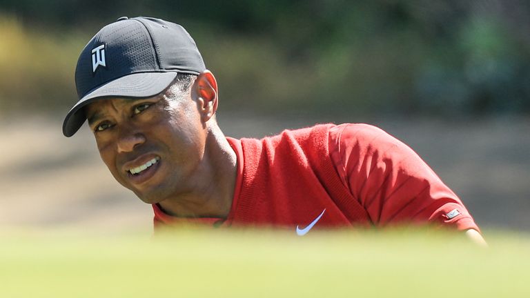 Tiger Woods recovered from a poor chip rolling back to his feet to make a hole-out birdie from the bunker at the par-five 17th during the final round
