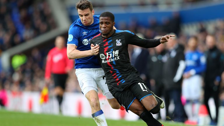 Zaha went to ground in the penalty area under a challenge from Seamus Coleman
