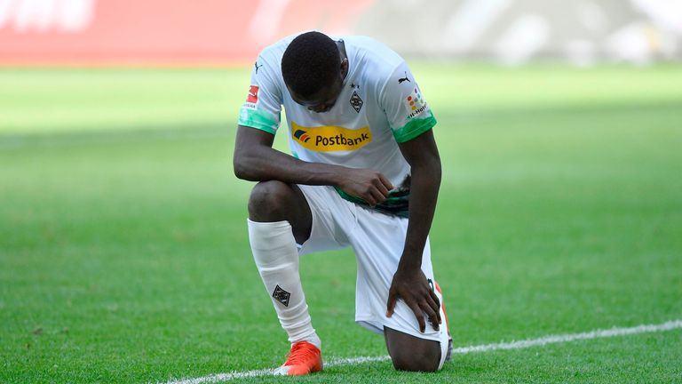 Marcus Thuram kneels after scoring for Borussia Monchengladbach against Union Berlin