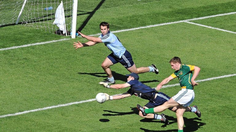 Stephen Bray scores Meath's third goal, as Stephen Cluxton and Bryan Cullen scramble for a block