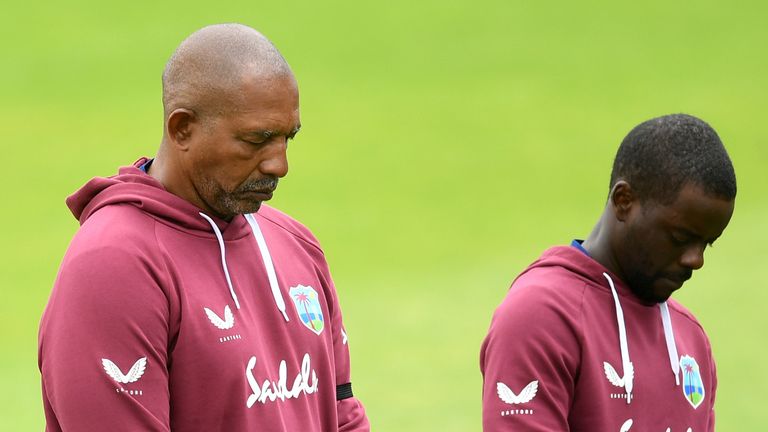 Phil Simmons, Head Coach of the West Indies (left) observes a minute's silence alongside his team in memory of former West Indies batsman Sir Everton Weekes