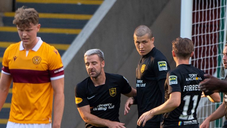 Dykes (centre) celebrates his goal against Motherwell